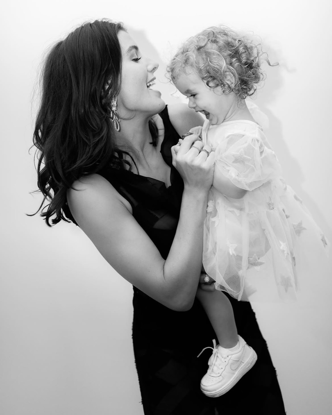 Bella, founder of Isabella Sofia, laughing with her daughter